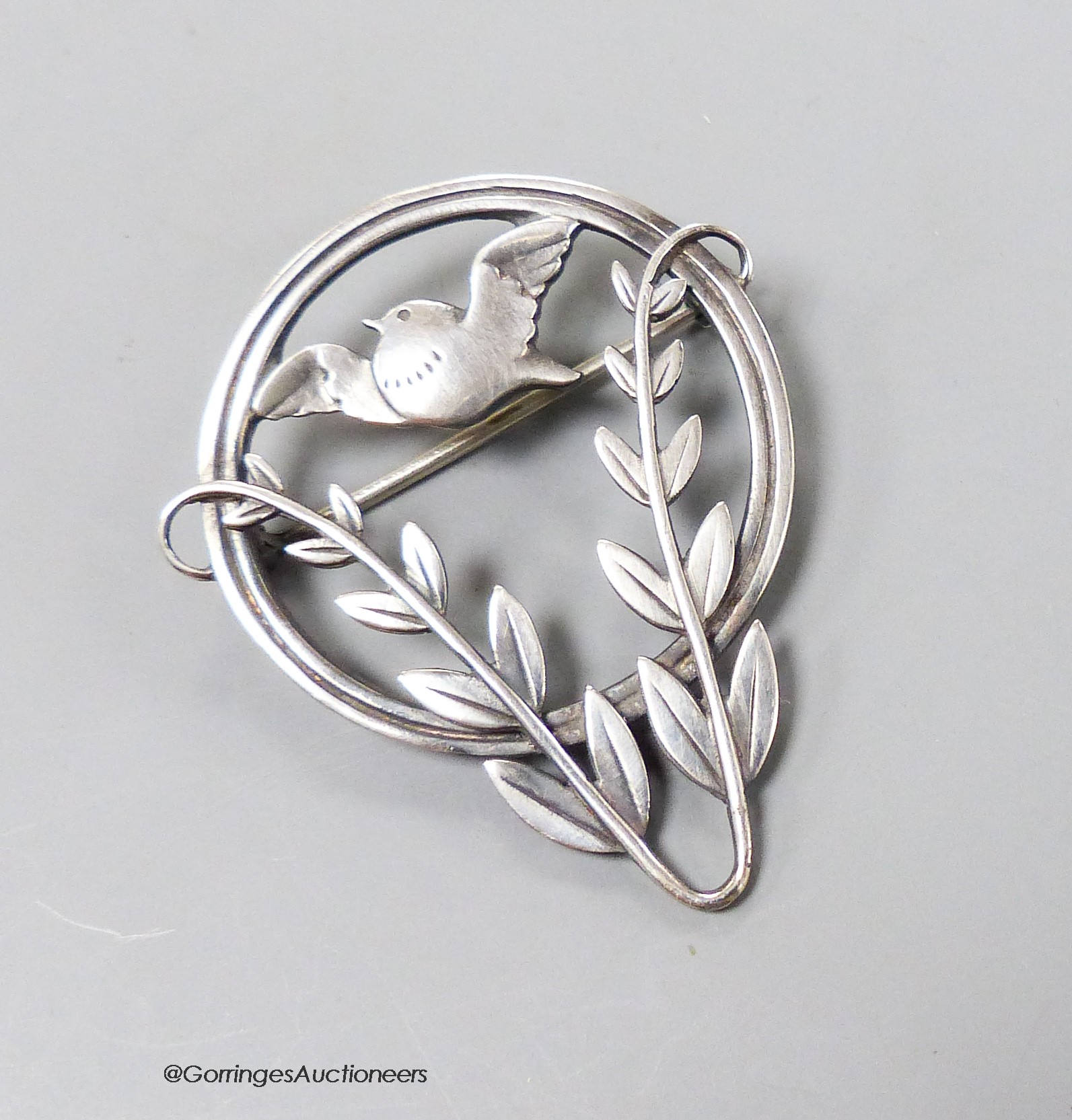 A Georg Jensen sterling circular framed 'bird amid foliage' brooch, designed by Arno Malinowski, no.258, 41mm